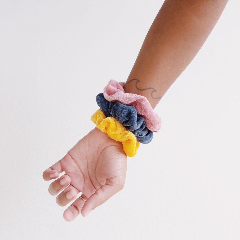pink, blue, and yellow velvet scrunchies